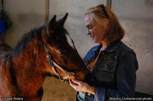 Malary Greenwood photo - “Foster Mom” Linda Harris talks sweetly to her rescued foal, Morning Star.